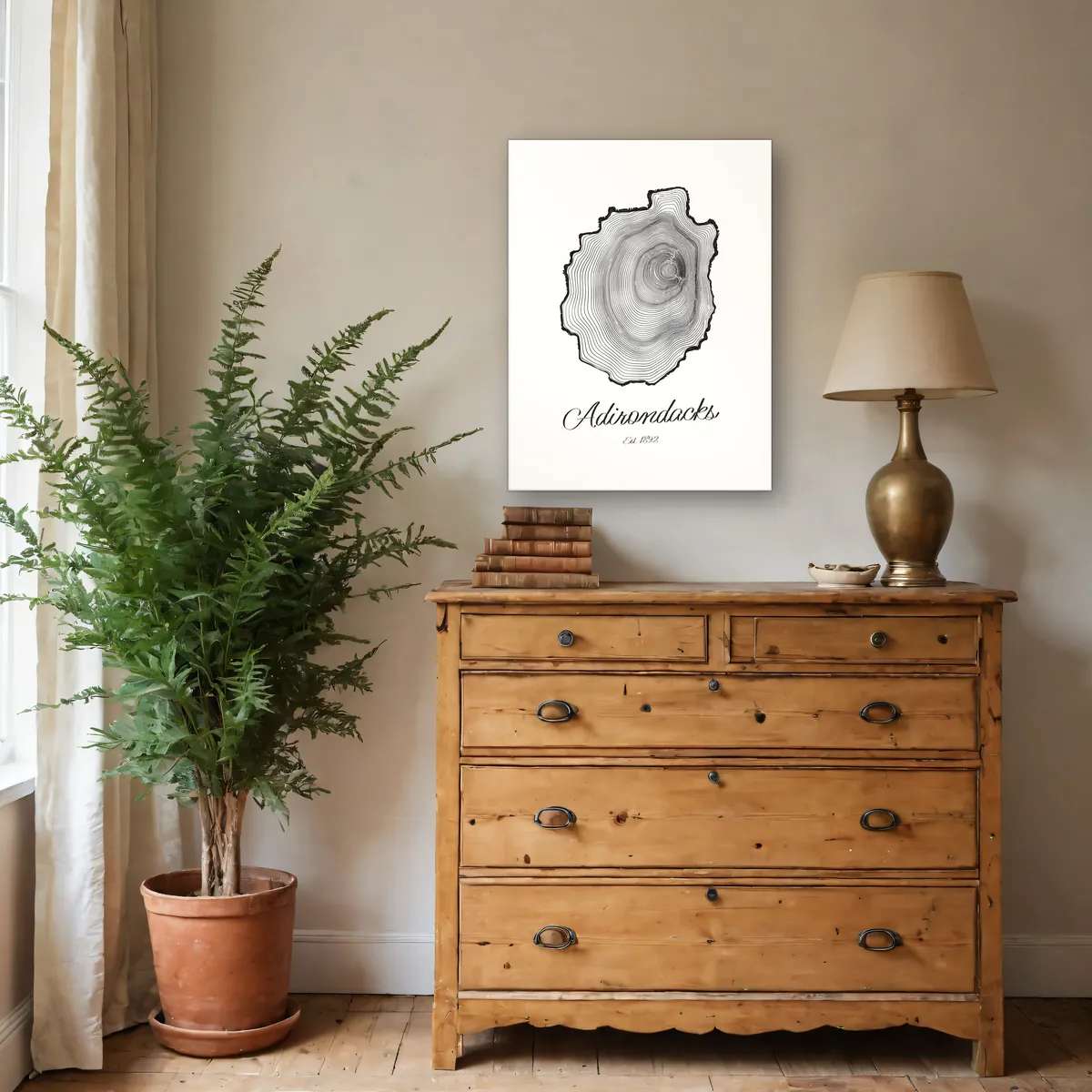 An 18 by 24 inch Ring & Ridge canvas of Adirondack tree rings hanging above a pine dresser. Shown in a rendered room.