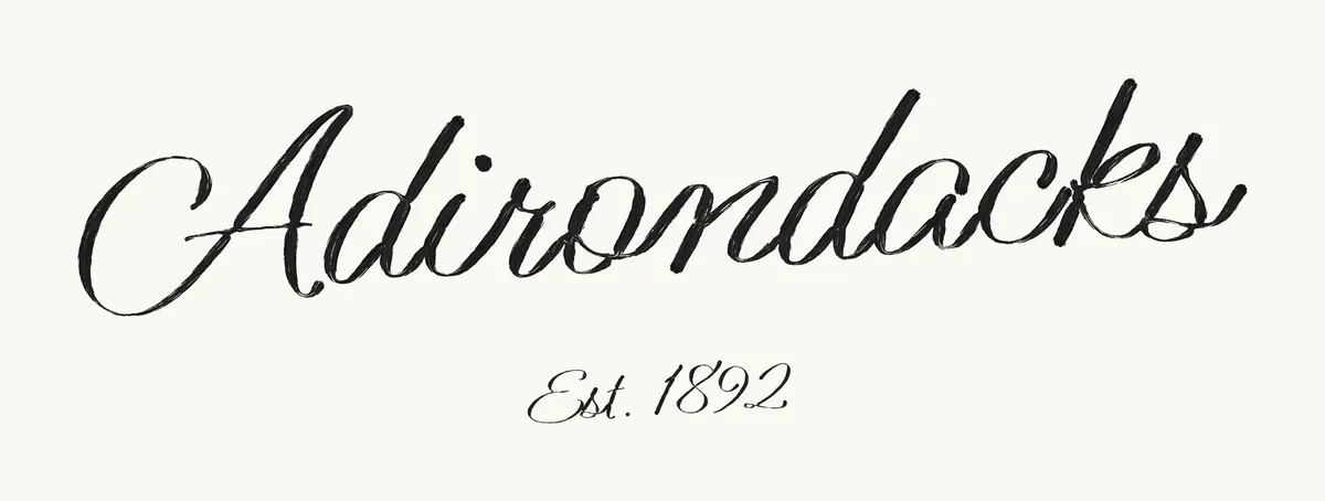 Close-up of the lettering: Adirondacks, Est. 1892, painted in a brush script.